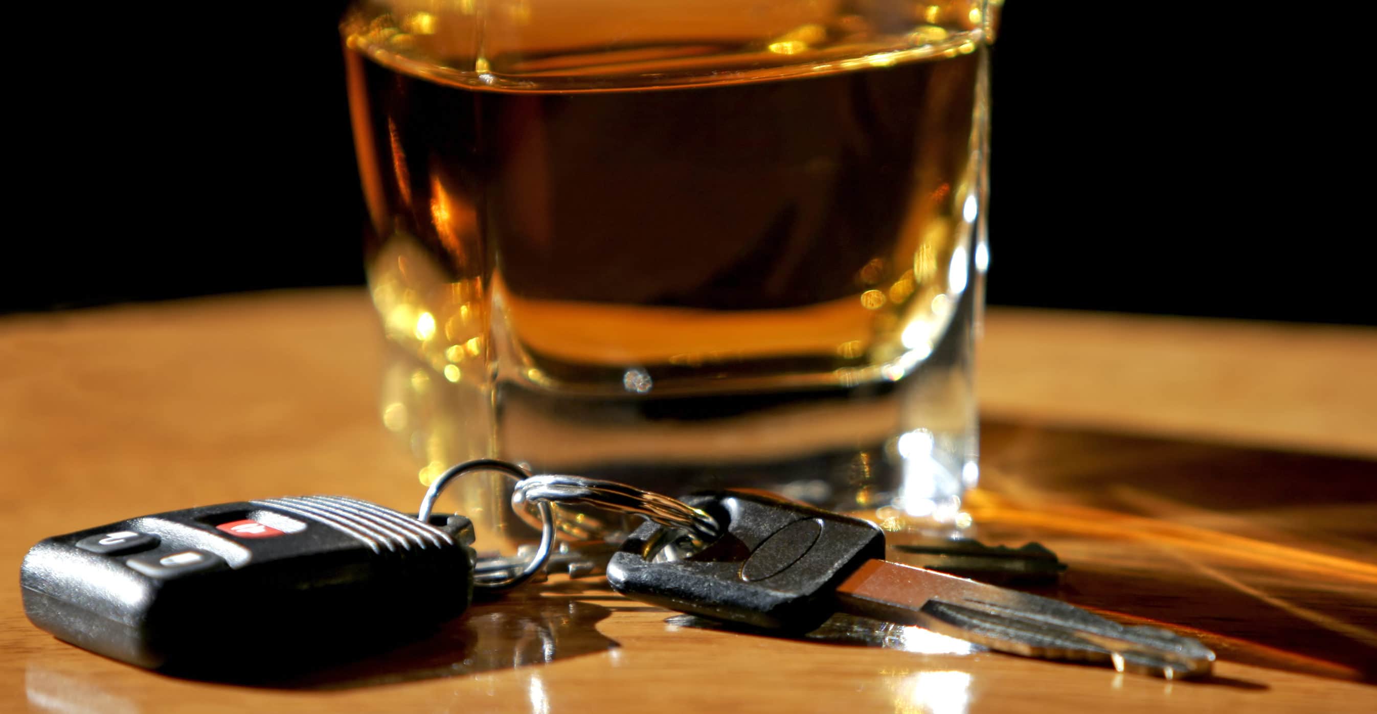 A cocktail and car keys sit on a counter, symbolizing drunk driving a potential DUI.